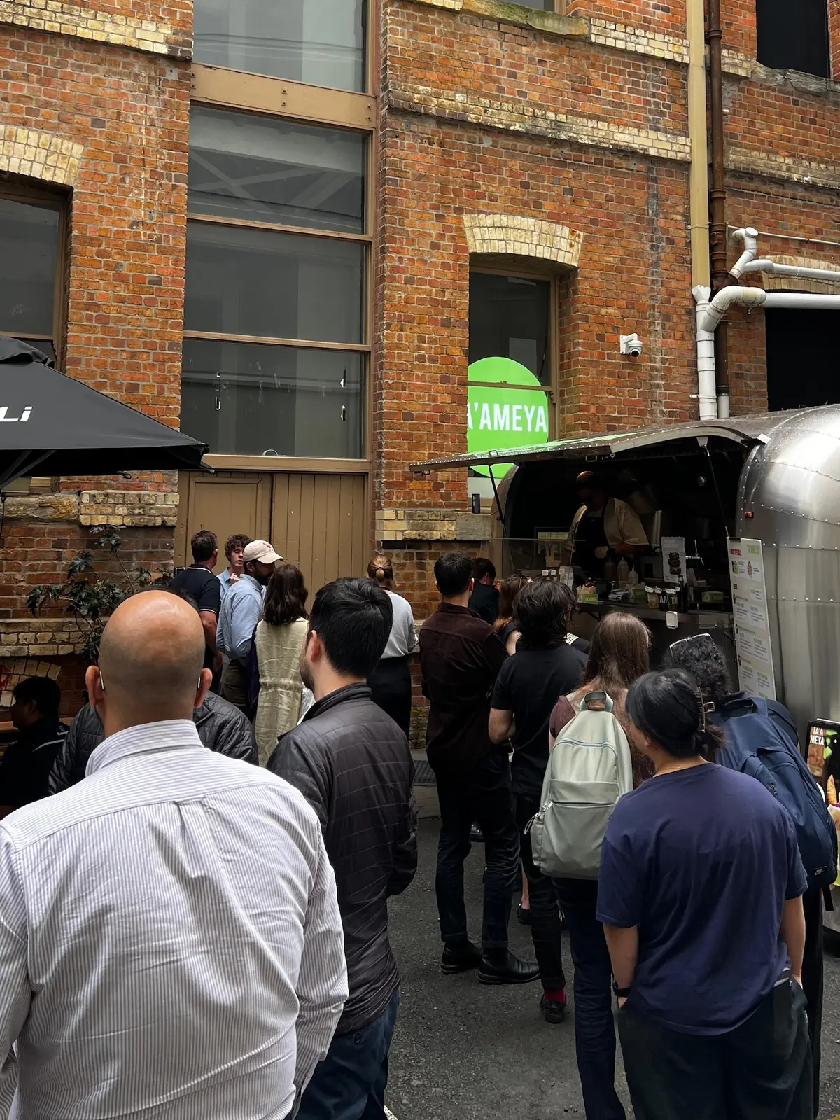 The Ta'ameya food trailer in Spencer Lane with a lunchtime queue
